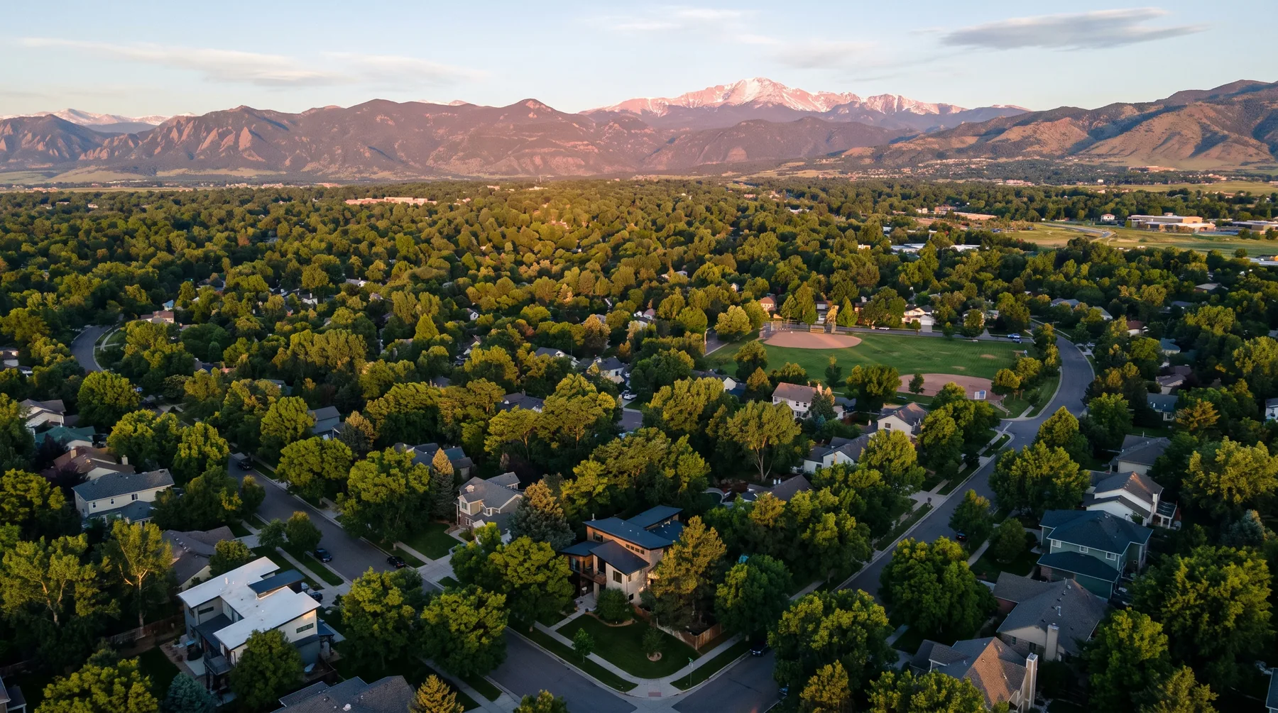Longmont rooftops at alpenglow with the mountains on the western skyline